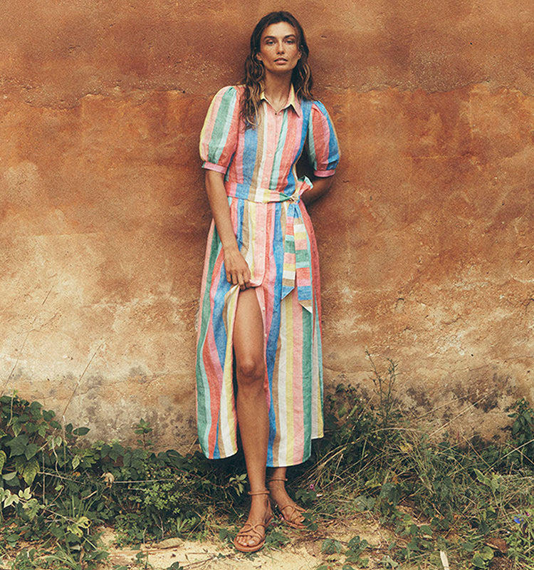 Woman standing in front of a wall wearing a Alexa Linen Maxi Shirt Dress