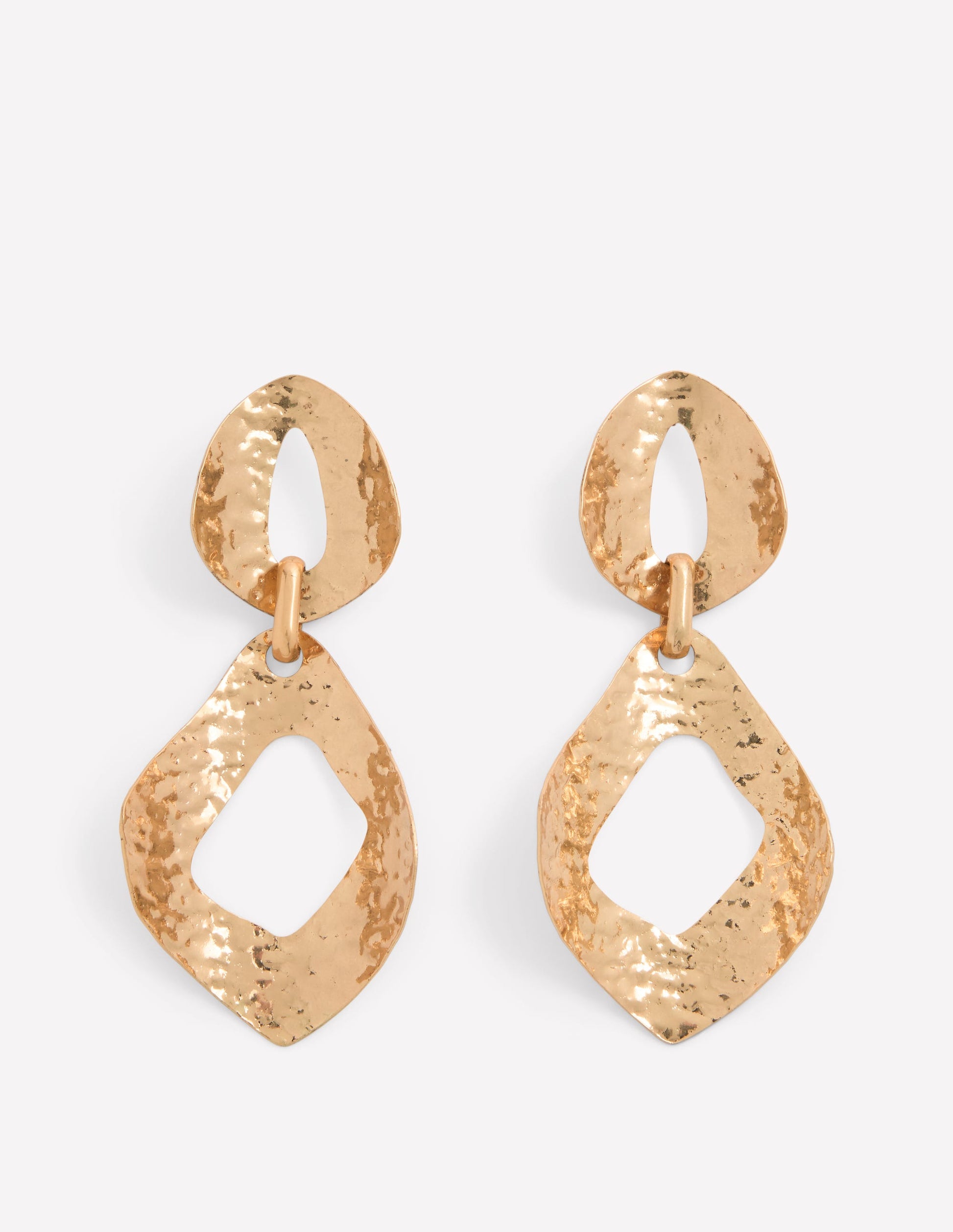 Gold earrings with a textured design on a white background