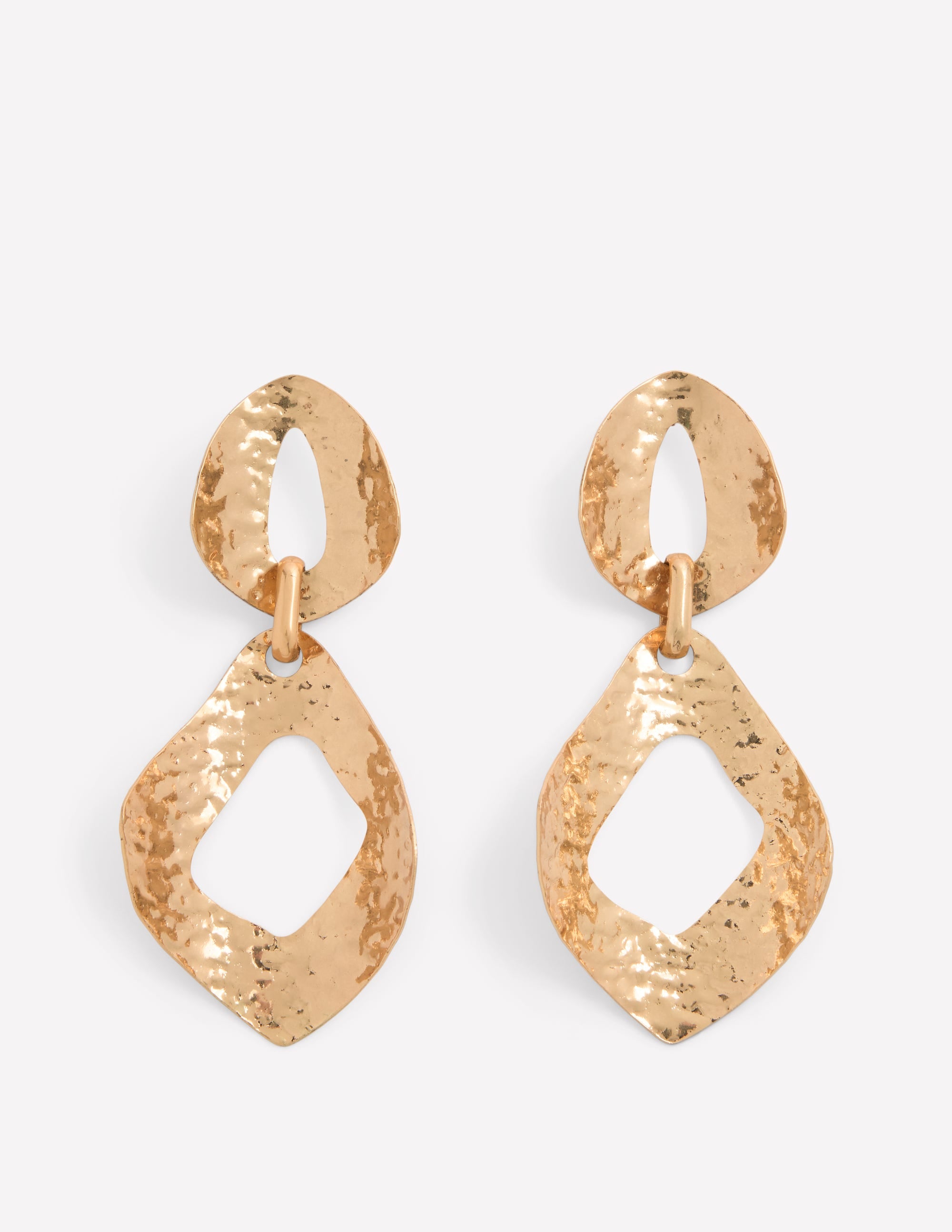 Gold earrings with a textured design on a white background