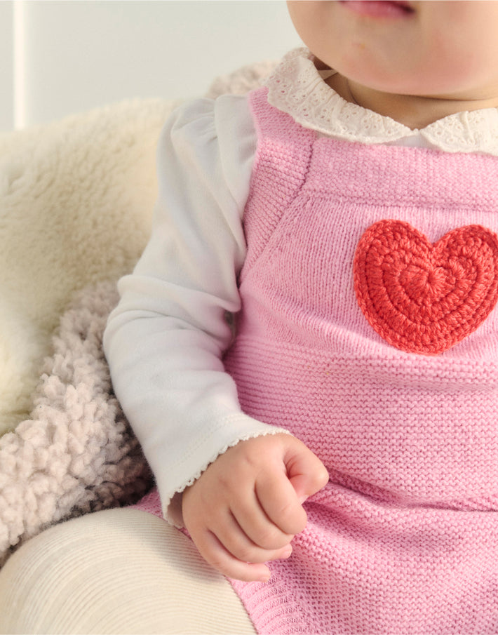 Close up of the heart detail on a baby boden knit outfit