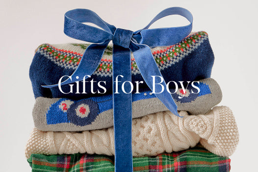 Stack of boys' clothing with a blue ribbon on a white background, labeled 'Gifts for Boys'.