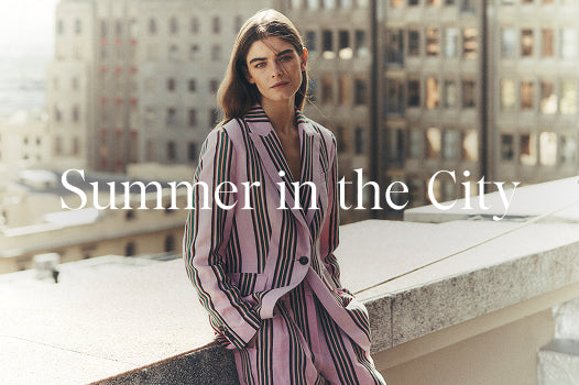 Woman in a striped outfit on a city rooftop with text 'Summer in the City'.