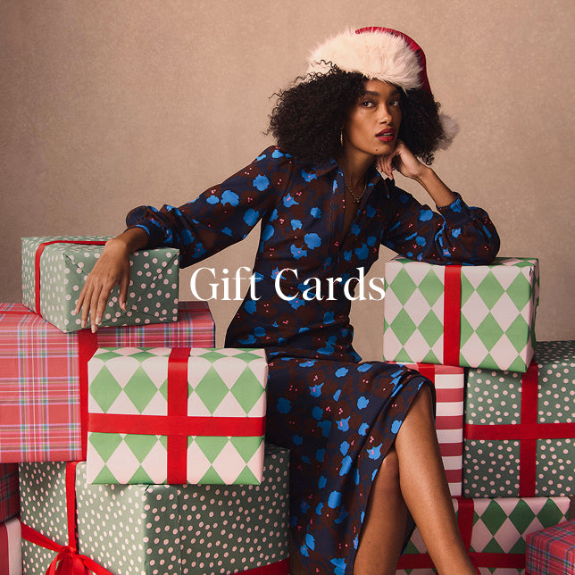 Woman in a festive outfit with Christmas-themed gift boxes