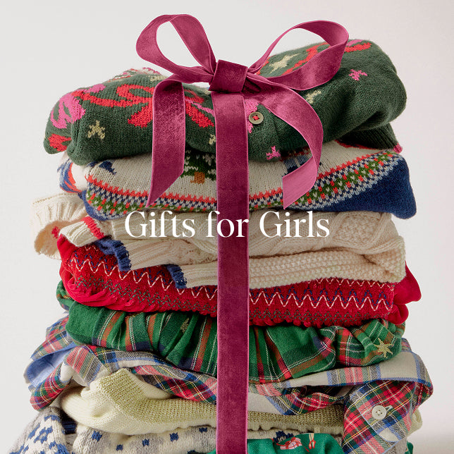 Stack of colorful children's sweaters tied with a pink ribbon on a white background, with text 'Gifts for Girls'.