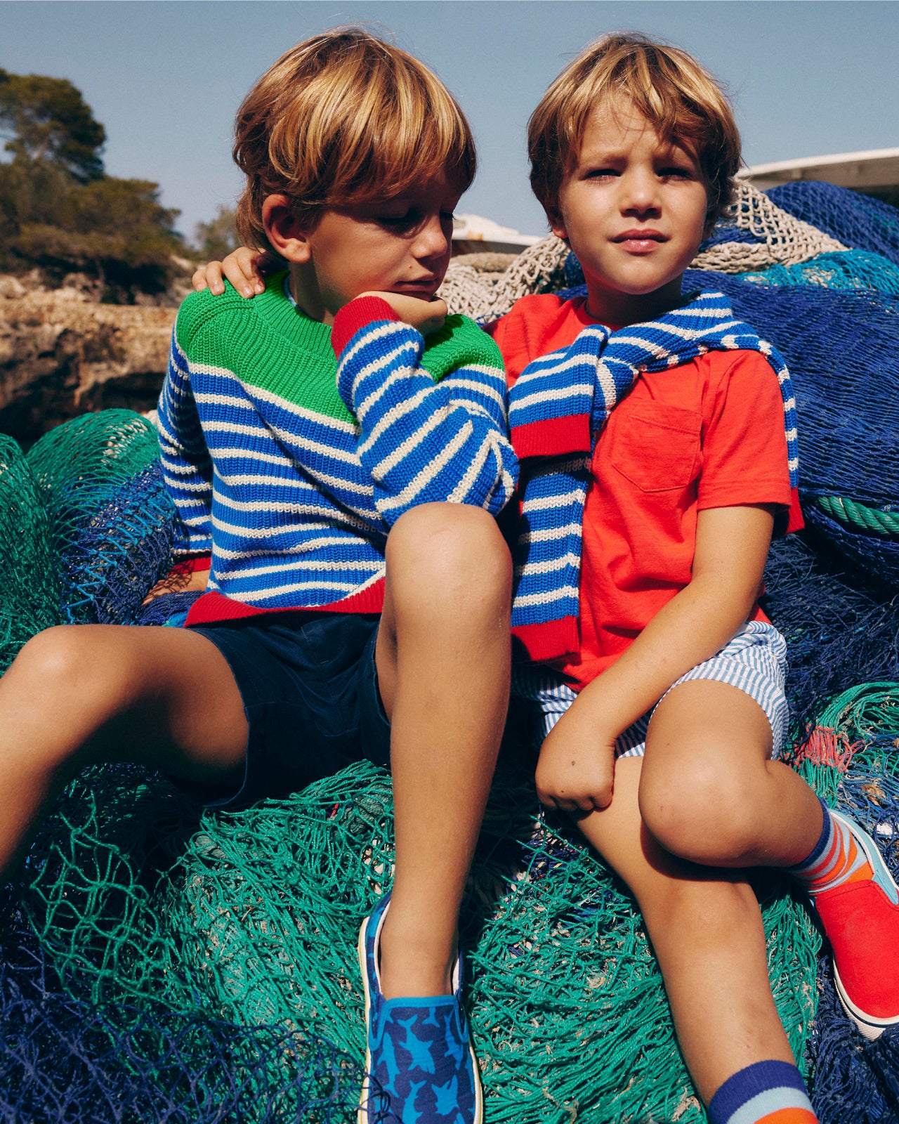 Two boys wearing Boden sweaters. Image link to Children's sweaters.