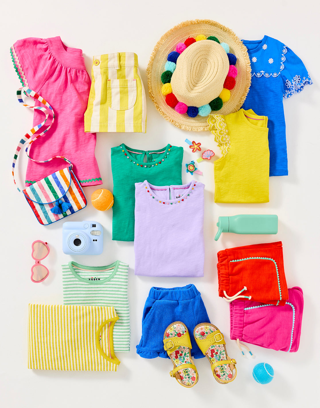 Colourful girl's Boden clothes folded and ready to be packed for summer camp