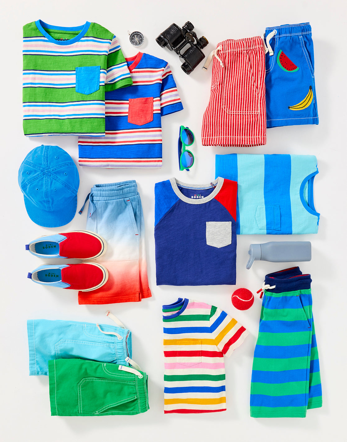 Colourful boy's Boden clothes folded and ready to be packed for summer camp