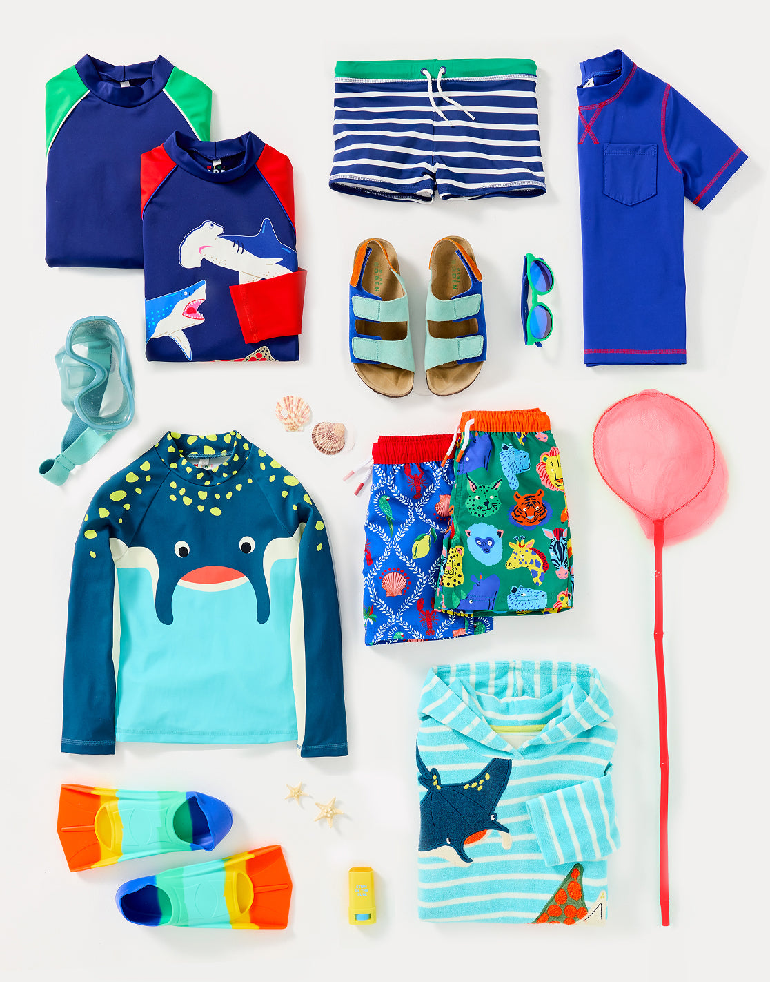 Colourful boy's Boden clothing, folded and ready to be packed for summer camp