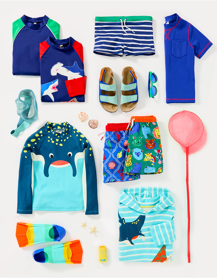 Colourful boy's Boden clothing, folded and ready to be packed for summer camp