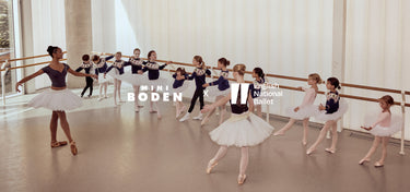 Ballet dancers in a studio with 'Mini Boden' and 'English Ballet' branding.