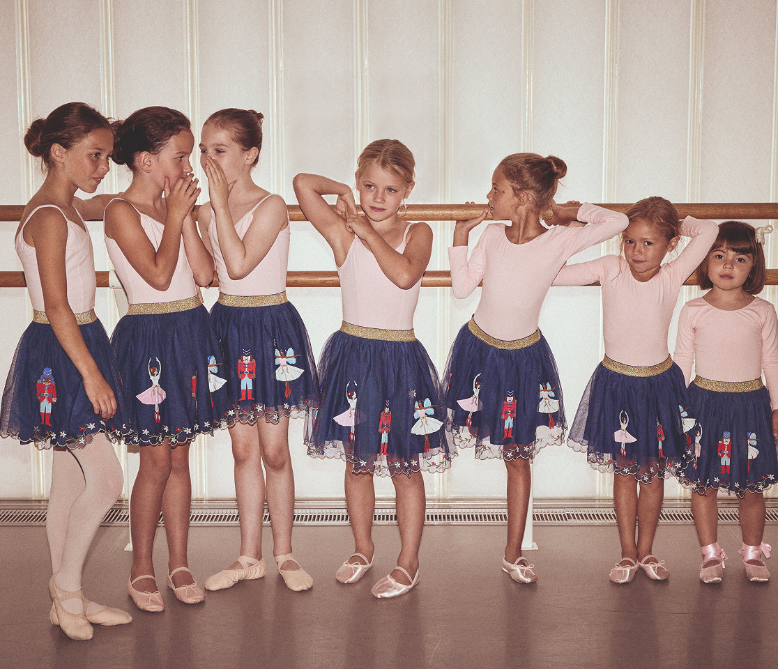 Group of young ballet dancers in a classroom setting
