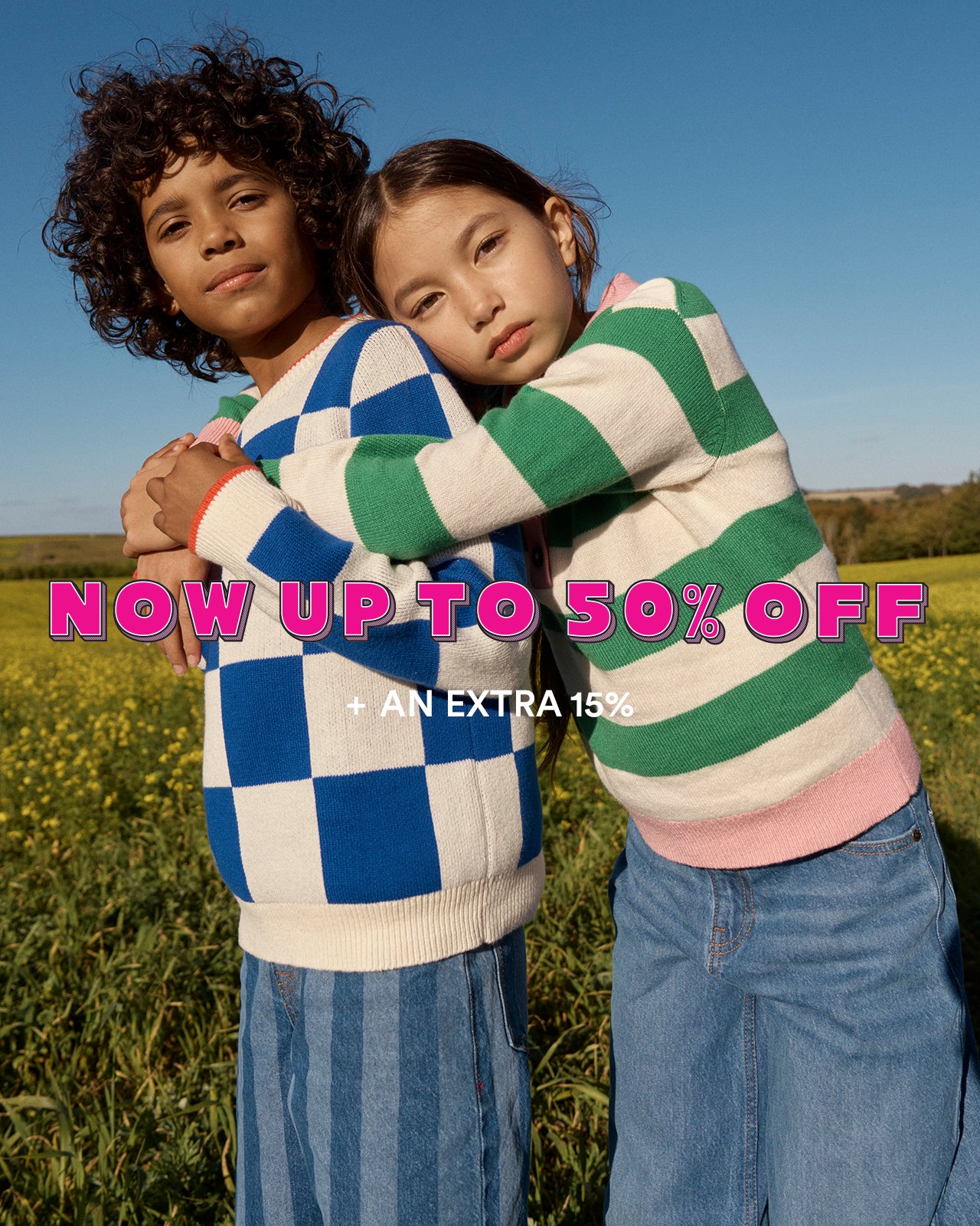 Two children hugging in a field with promotional text overlay