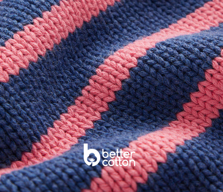 Close-up of blue and pink striped fabric with 'Better Cotton' logo.
