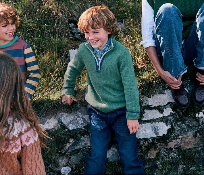 Children standing on a stone path in a natural setting