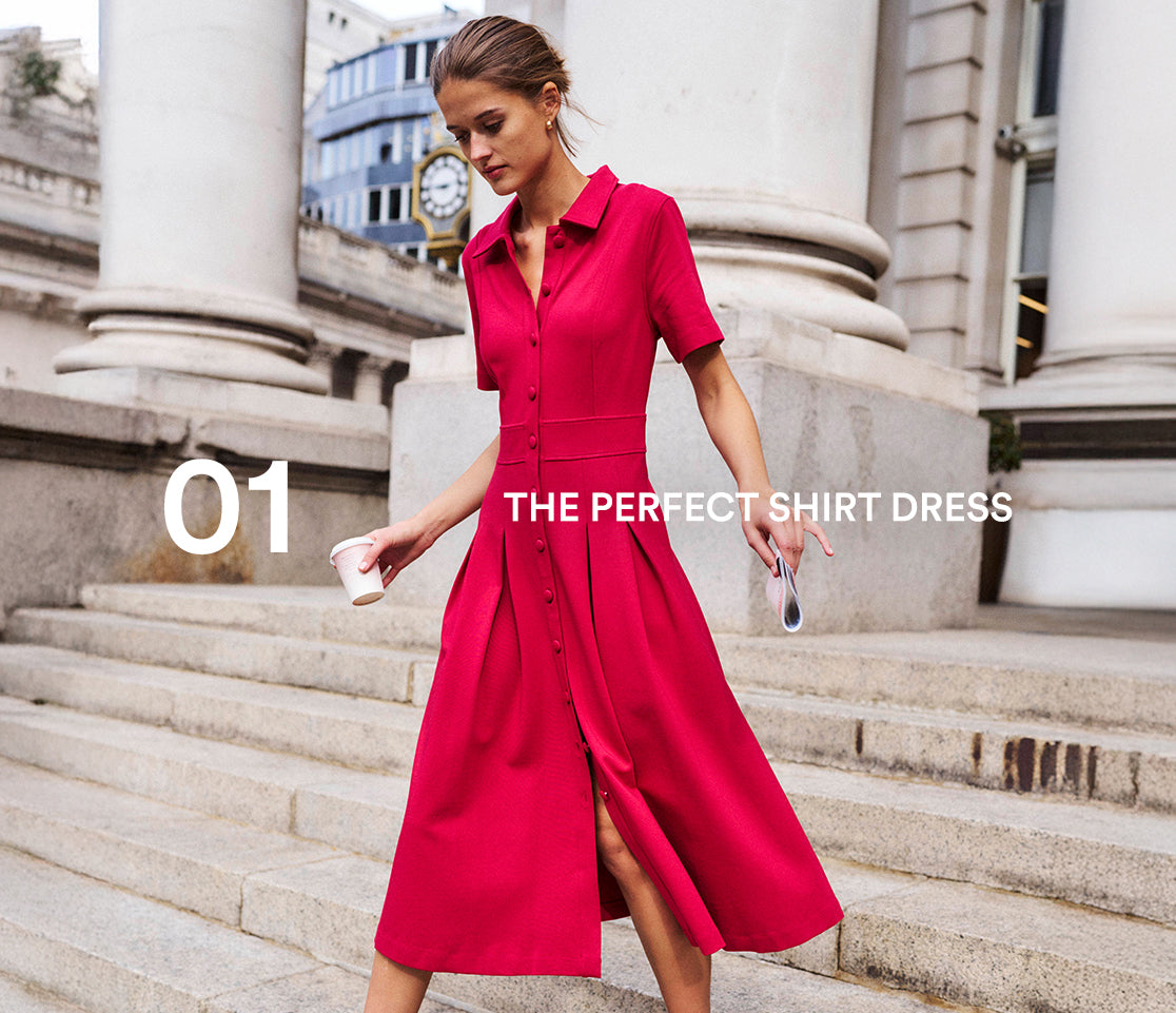 Woman in a red dress standing on stone steps with classical architecture in the background