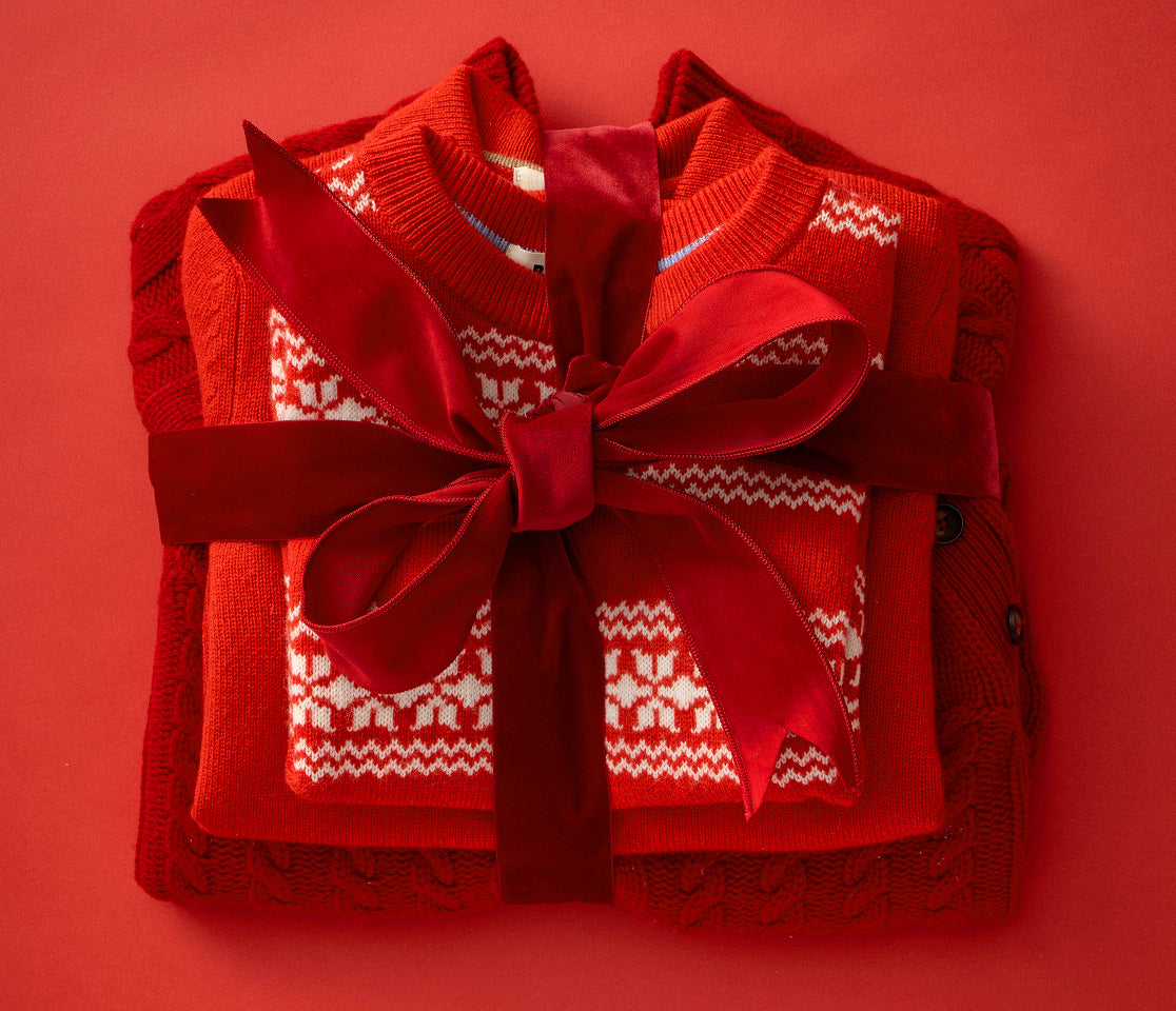 Red knitted sweater with white pattern on a red background