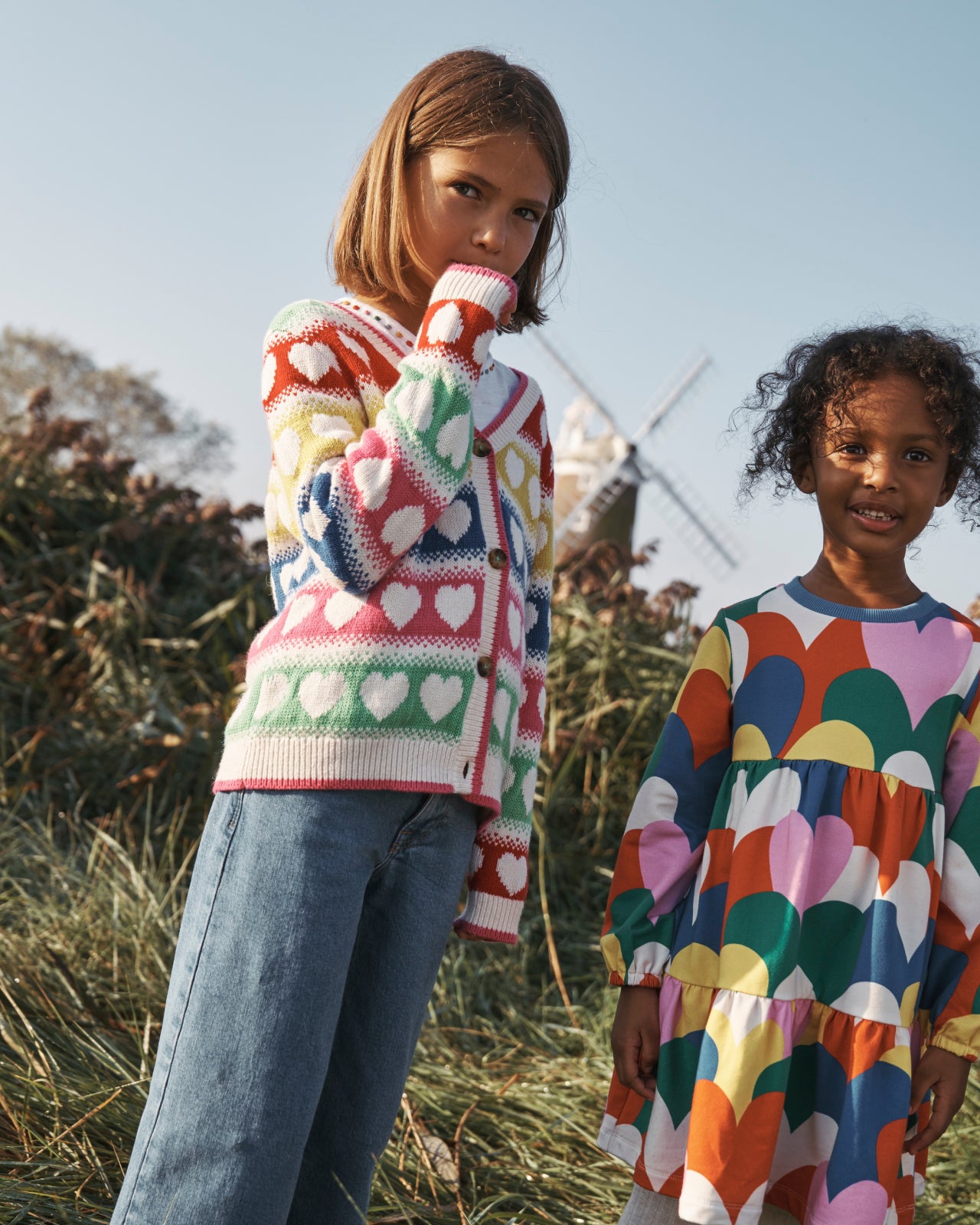 Girl wearing Boden Flora Fun V-Neck Cardigan-Rainbow Hearts