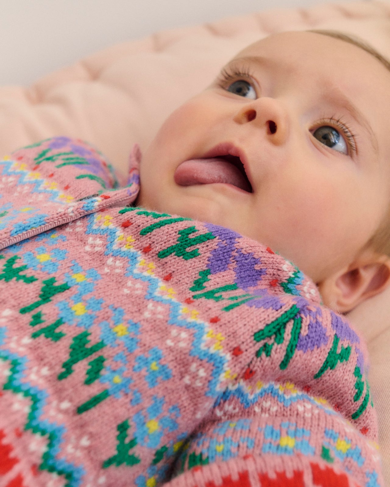 Baby wearing Edie Fair Isle Cardigan-Bubblegum Pink Flowers