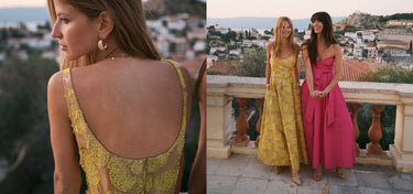 Two women in colorful dresses standing on a balcony with a scenic view.