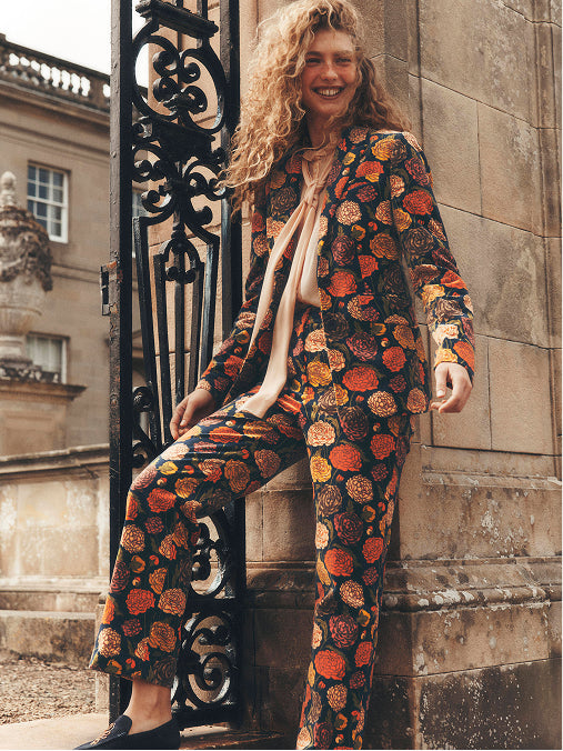 A woman wearing a flower print tailored suit