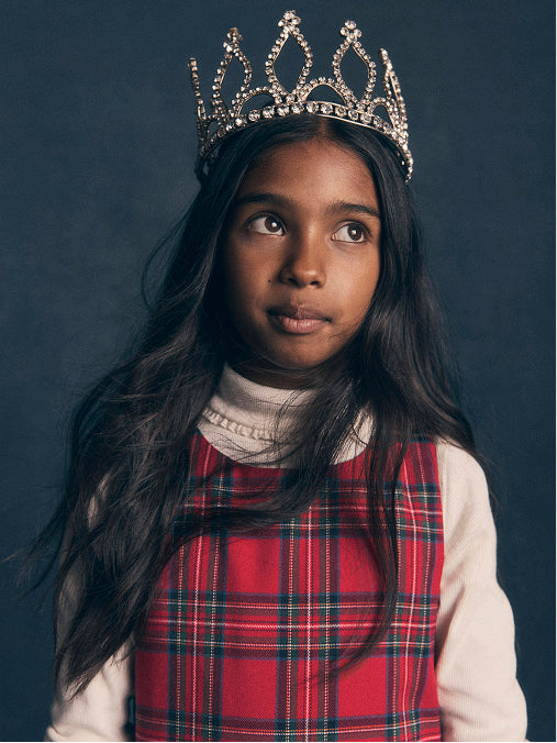 Girl wearing a Tartan dress with a white top 