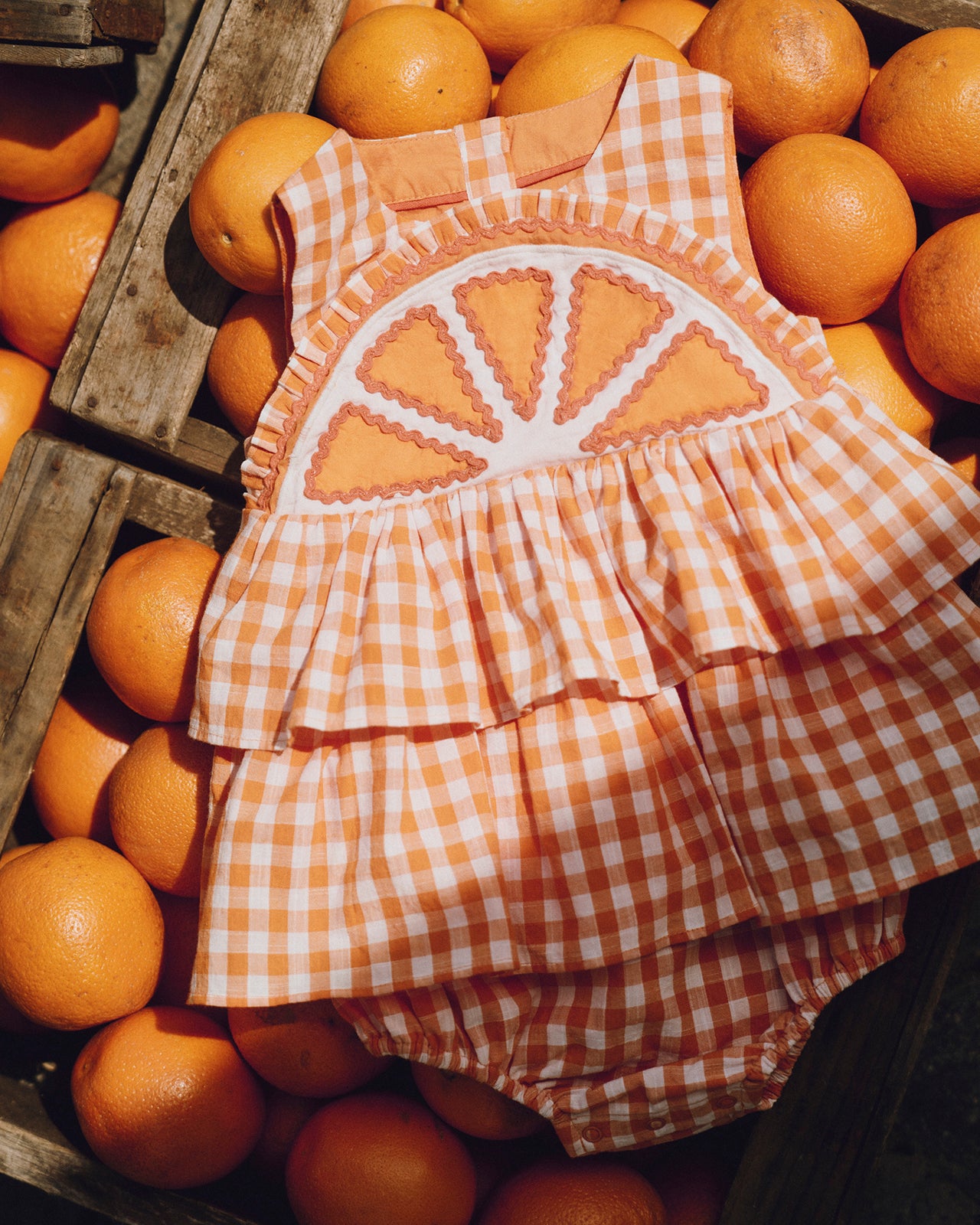 Checkered dress with orange design on a background of oranges