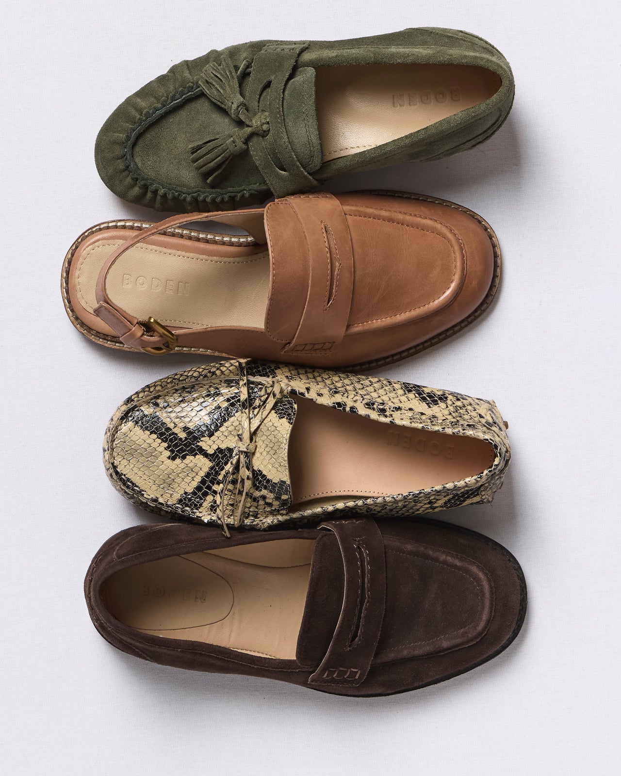 Four pairs of loafers in different colors and patterns on a white background
