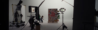 Studio setup with equipment and a person in a room with a colorful poster.