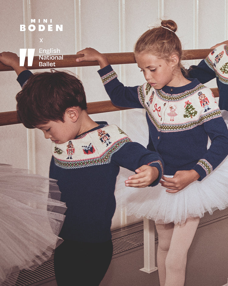 Two children in ballet attire with a Mini Boden and English National Ballet logo.