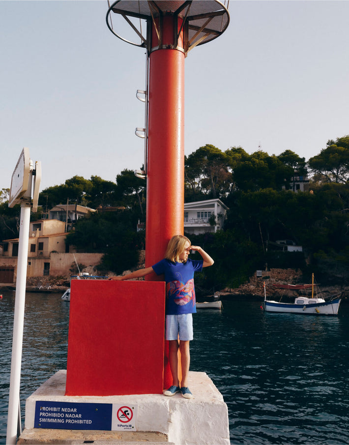 Boy standing by the sea. Image link to Superstitch T-Shirt-Sapphire.