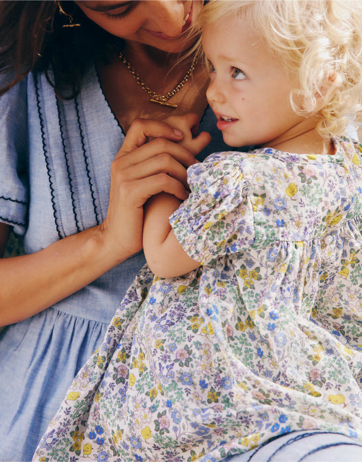 Girl wearing Boden dress, linking to Gathered Woven Dress - Multi Chick Floral