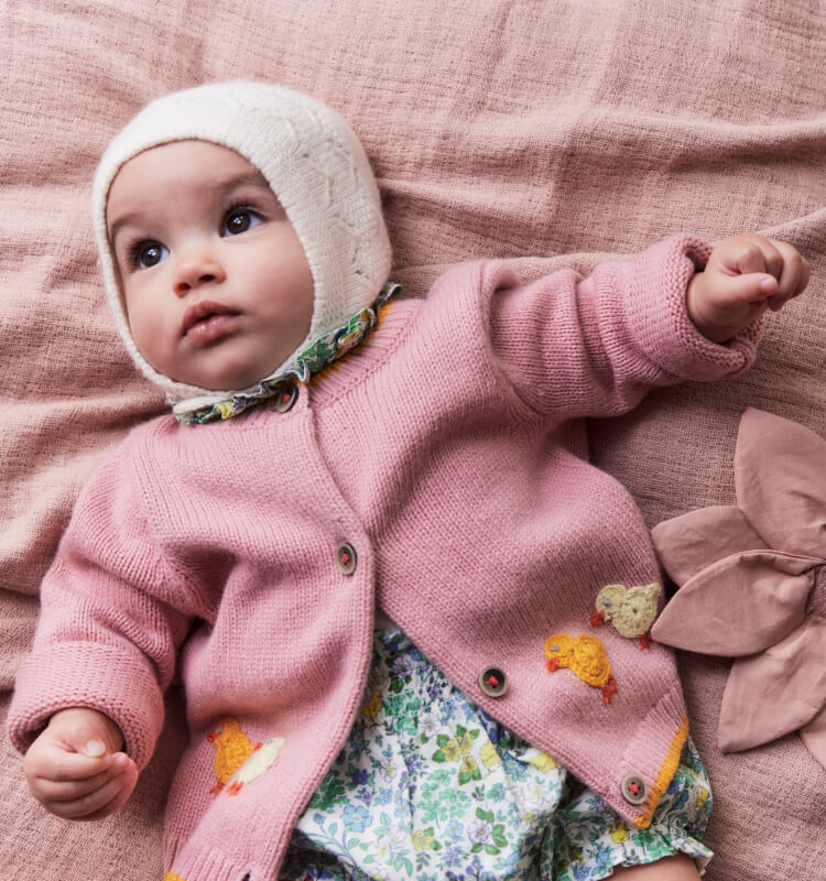 Baby girl wearing Boden knitwear