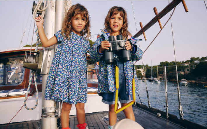 Two girls wearing Boden on a boat, linking to Waterproof Fisherman's Jacket - Sapphire Blue Nautical Floral