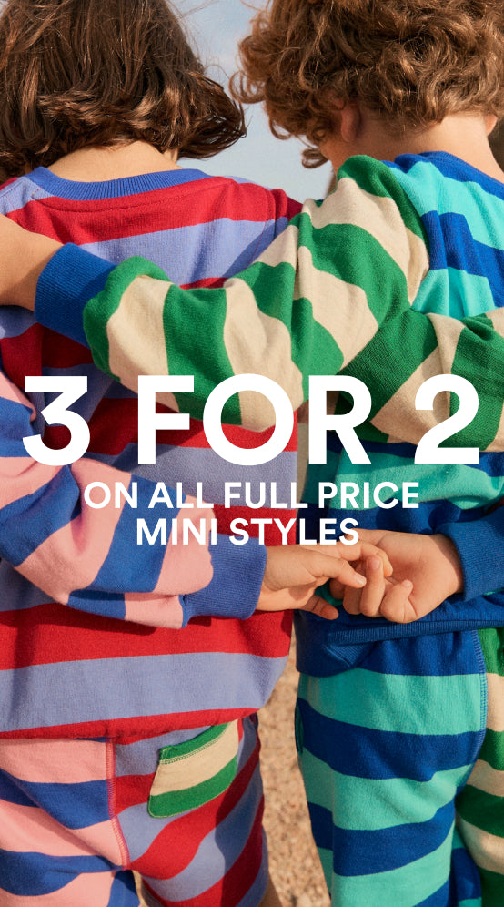 Two children wearing colorful striped outfits with promotional 3 for 2 text overlay.