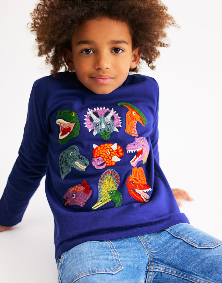 Child wearing long-sleeve Boden shirt, linking to Fun Superstitch Grid T-Shirt - Sapphire Blue Dino