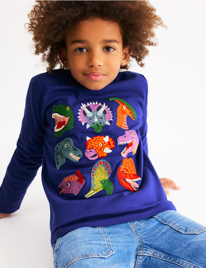 Child wearing long-sleeve Boden shirt, linking to Fun Superstitch Grid T-Shirt - Sapphire Blue Dino