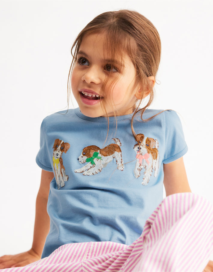 Girl wearing Boden t-shirt, linking to Puff Sleeve Superstitch Top - Glacier Blue Dogs