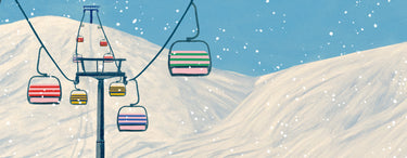 Colorful ski lift cabins against a snowy mountain landscape with a blue sky.