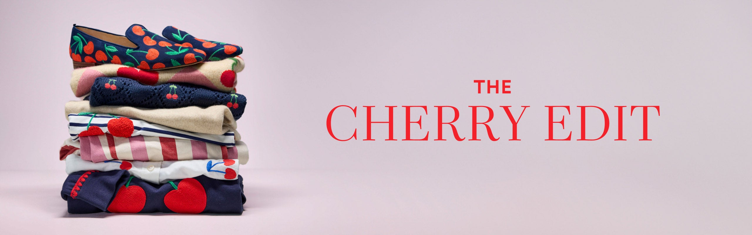 "The Cherry Edit", folded pile of Boden clothes and a pair of shoes with cherry print