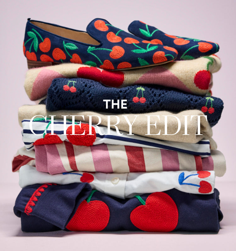 "The Cherry Edit", folded pile of Boden clothes and a pair of shoes with cherry print