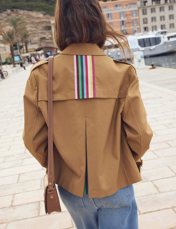 Woman showing the back of her Boden coat, linking to Mayfair Cropped Trench - Hazelnut Brown