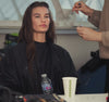 Video montage of model getting ready for shoot, posing in white jumpsuit and other denim clothing. Links to women's denim collection.